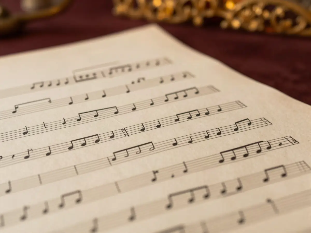 An adult looking overwhelmed at a dense page of sheet music